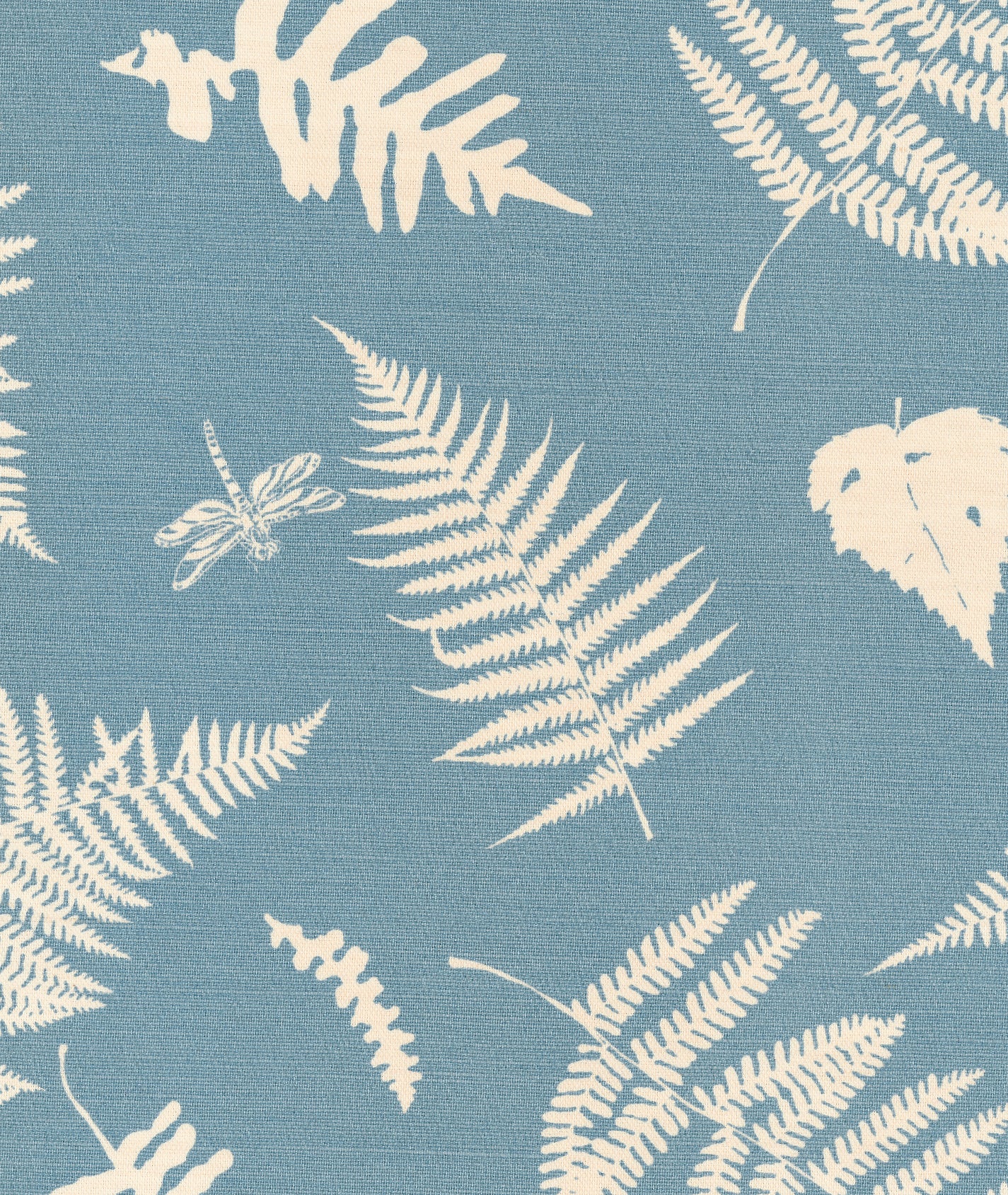 Detail of fabric in a repeating fern and dragonfly print in cream on a blue field.