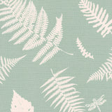 Detail of fabric in a repeating fern and dragonfly print in cream on a light green field.