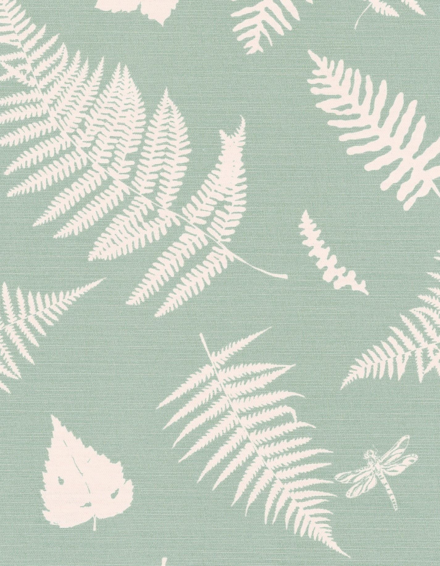 Detail of fabric in a repeating fern and dragonfly print in cream on a light green field.