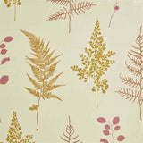 Close-up of fabric in a repeating leaf print in pink and mustard on a cream field.