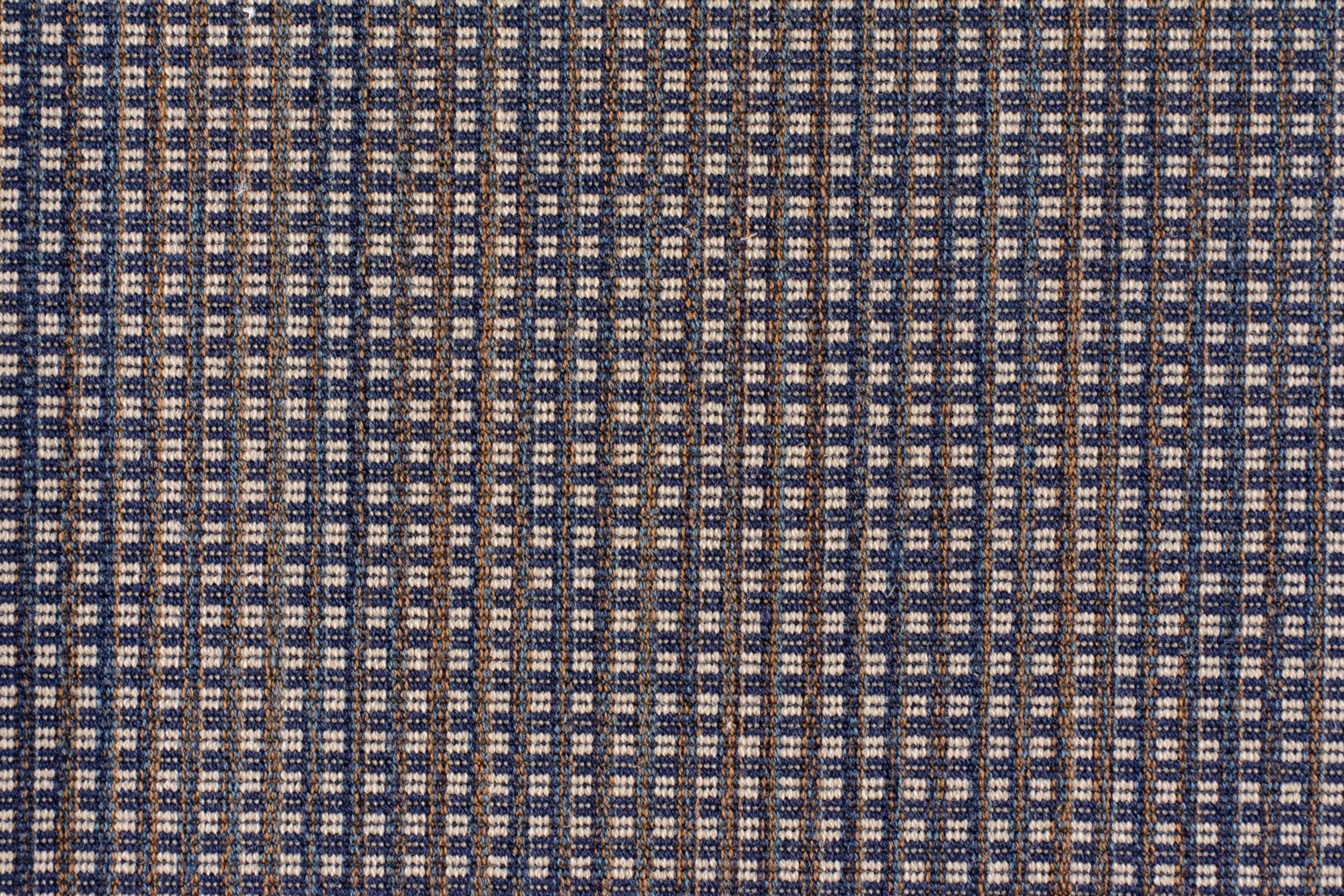 Broadloom carpet with a blue and beige checkered pattern