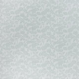 printed cotton fabric in a repeating fish and leaf pattern in light green on a gray field.