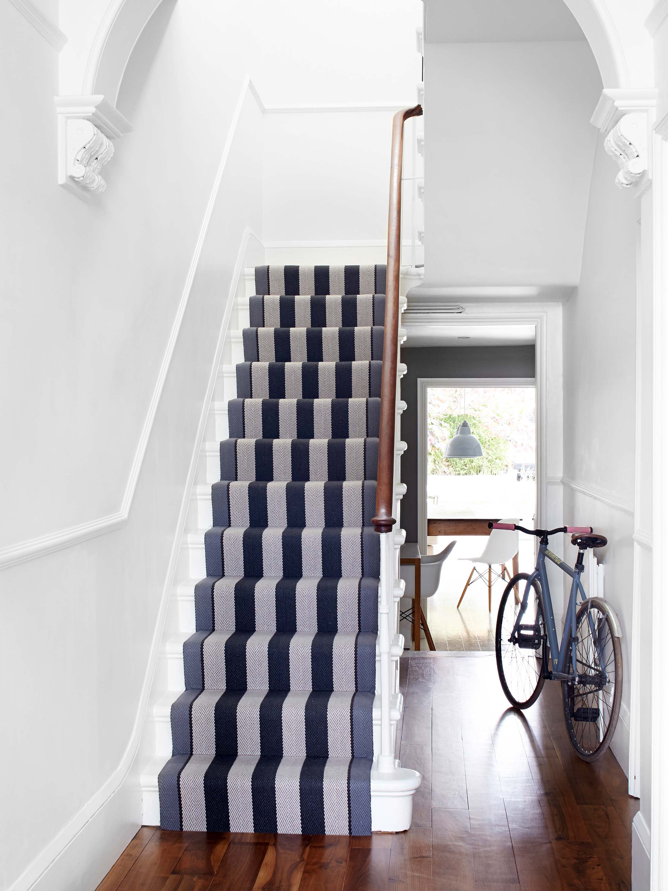 Striped flatweave runner in black and white on white staircase