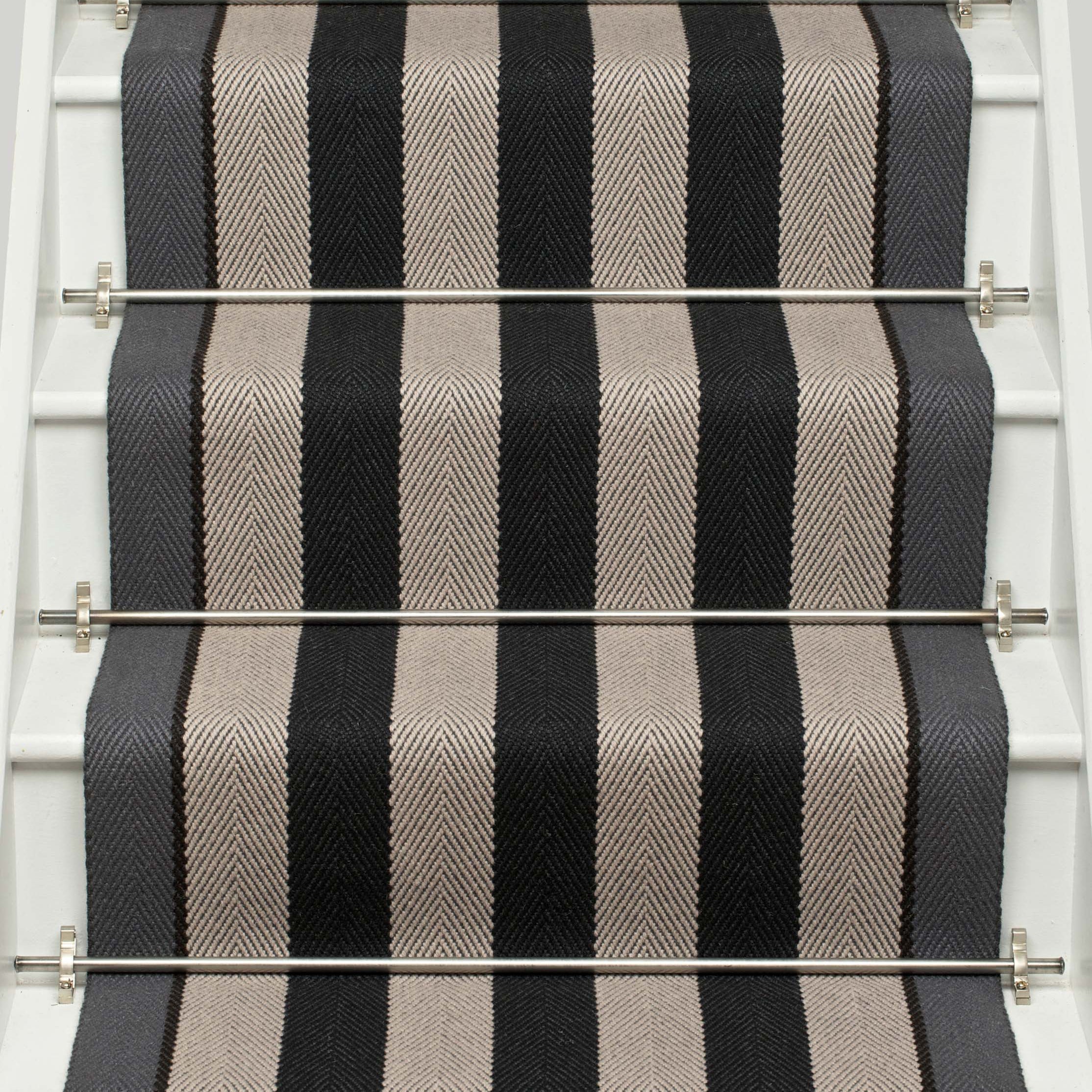 Striped flatweave runner in black and white on white staircase