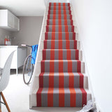 Striped flatweave runner in red and orange on white staircase