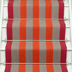 Striped flatweave runner in orange and red and white staircase