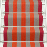 Striped flatweave runner in orange and red and white staircase