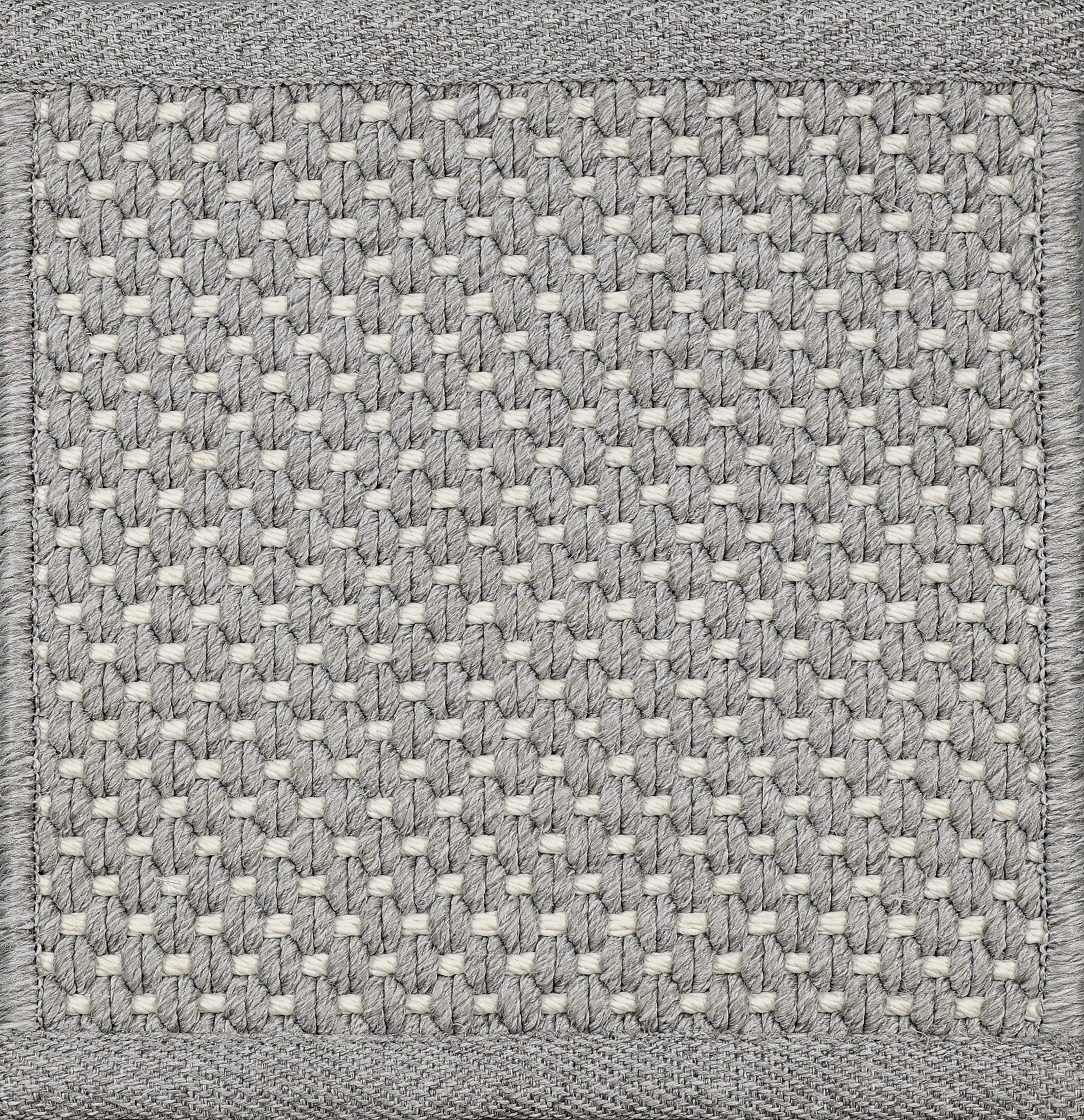 Close-up of woven carpet with a grid pattern in gray and white.