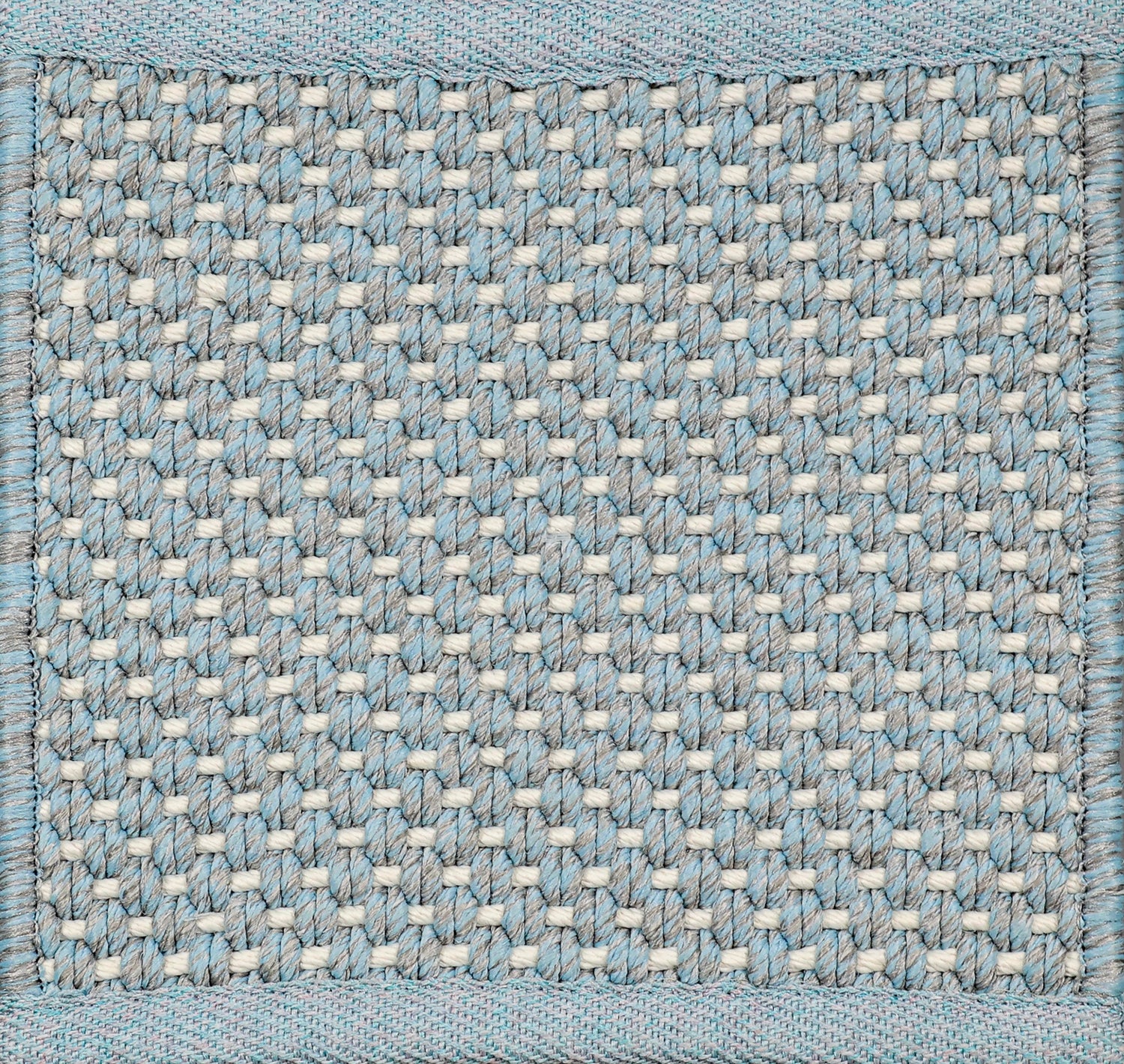 Close-up of woven carpet with a grid pattern in blue, grey and white.