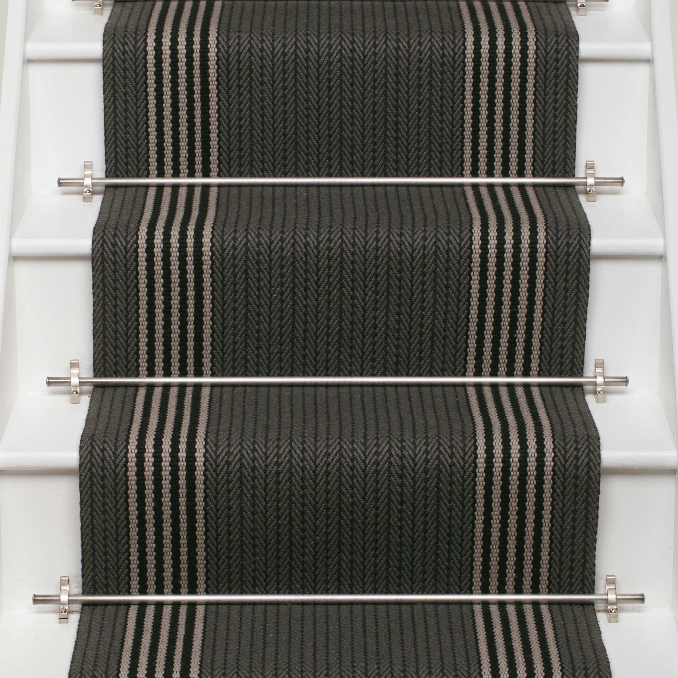 Striped flatweave runner in dark grey and white and black on white staircase