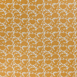 printed linen-cotton fabric in a repeating geometric flower pattern in burnt orange on a white field.