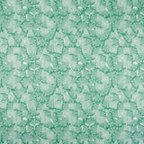 Detail of fabric in a dense petal print in shades of turquoise on a white field.