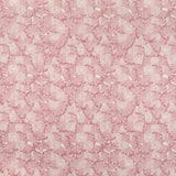 Detail of fabric in a dense petal print in shades of pink on a white field.