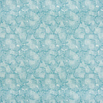 Detail of fabric in a dense petal print in shades of blue on a white field.