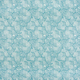 Detail of fabric in a dense petal print in shades of blue on a white field.