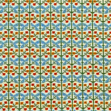 Patterned fabric with a gridded floral design in green, orange and blue. 
