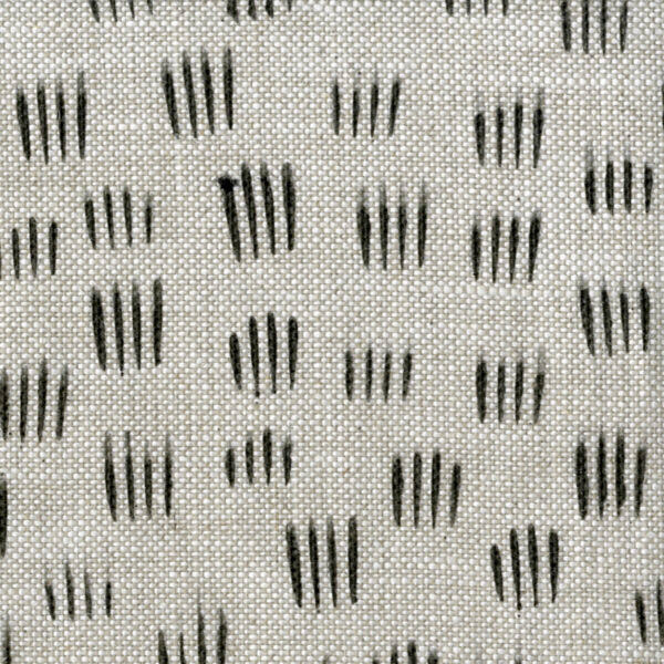 Fabric in a repeating dash print in black on a gray field.