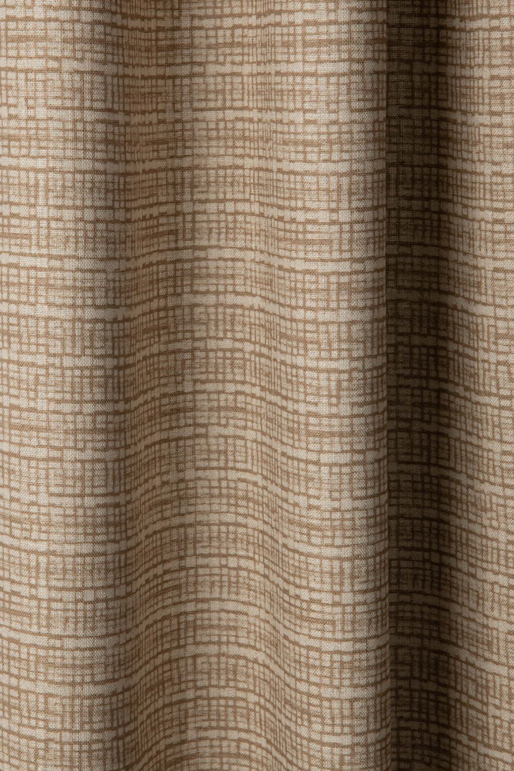 Draped linen fabric in a repeating abstract gridded pattern in tan on a cream field.