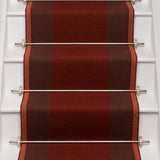 Striped flatweave runner in red and brown on white staircase