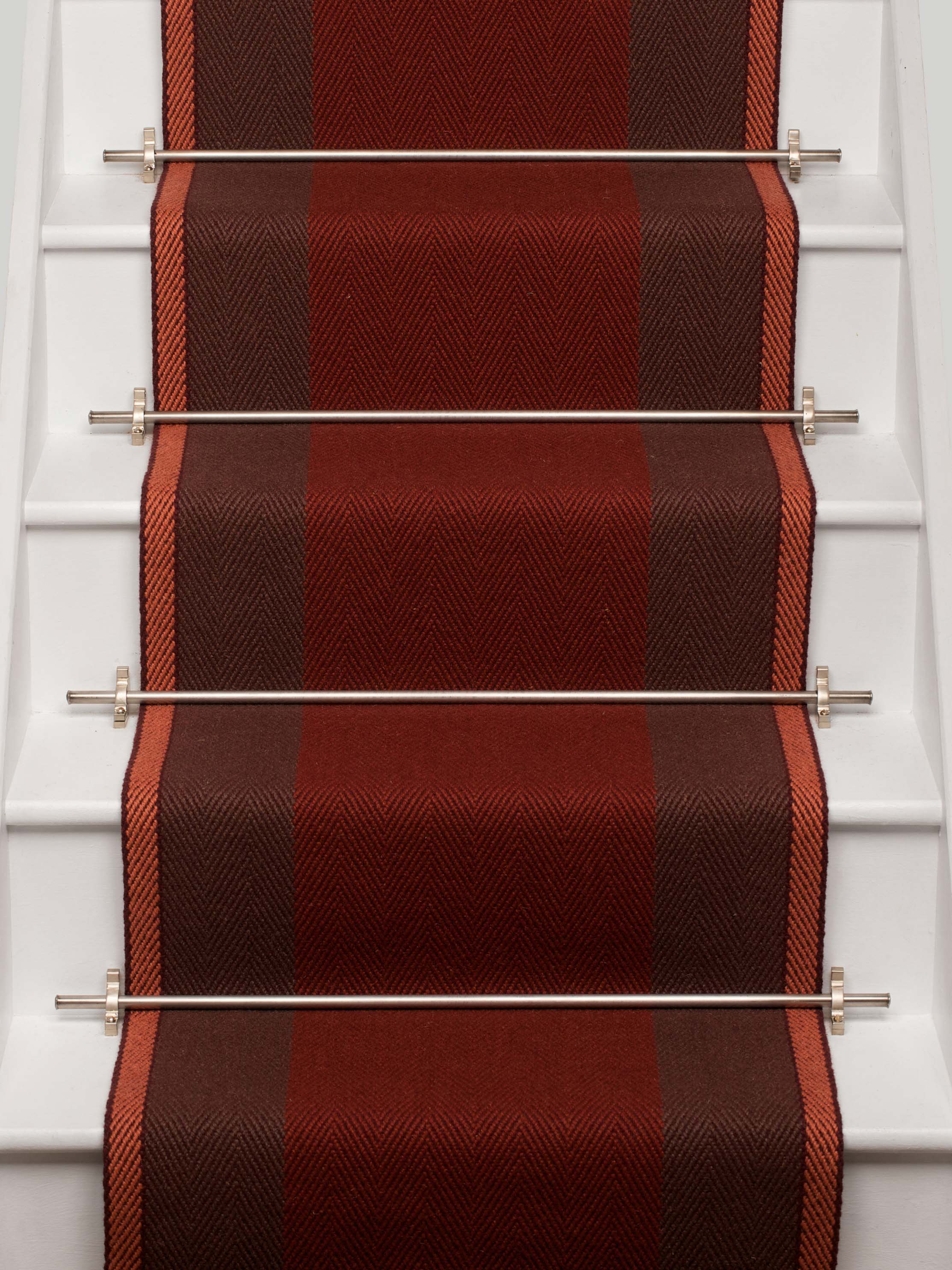 Striped flatweave runner in red and brown on white staircase