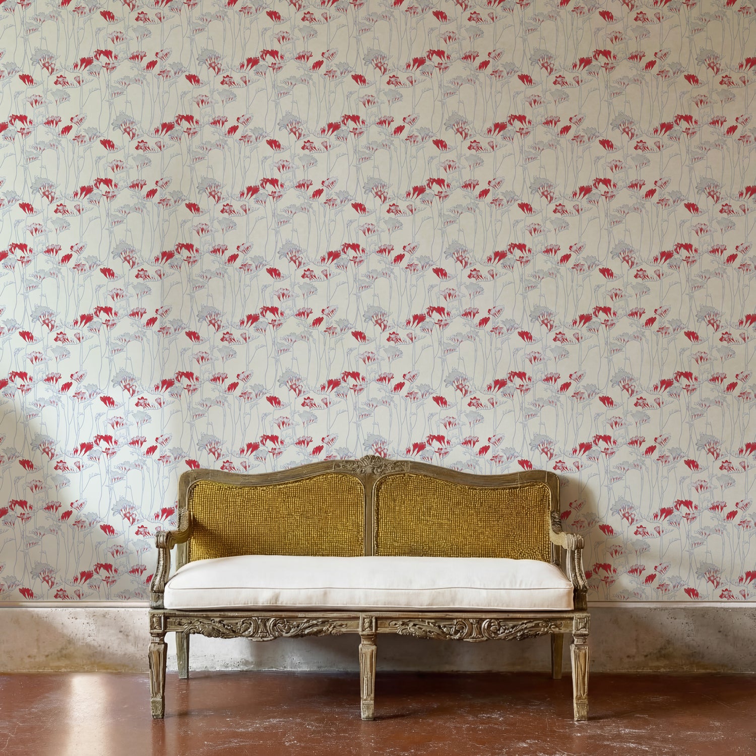 Decorative bench against a red and grey floral wallpapered wall