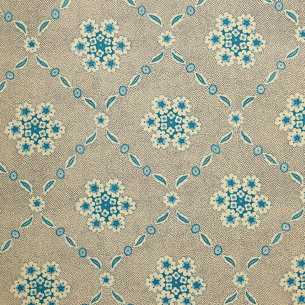 Detail of wallpaper in an intricate floral lattice print in blue on a tan field.