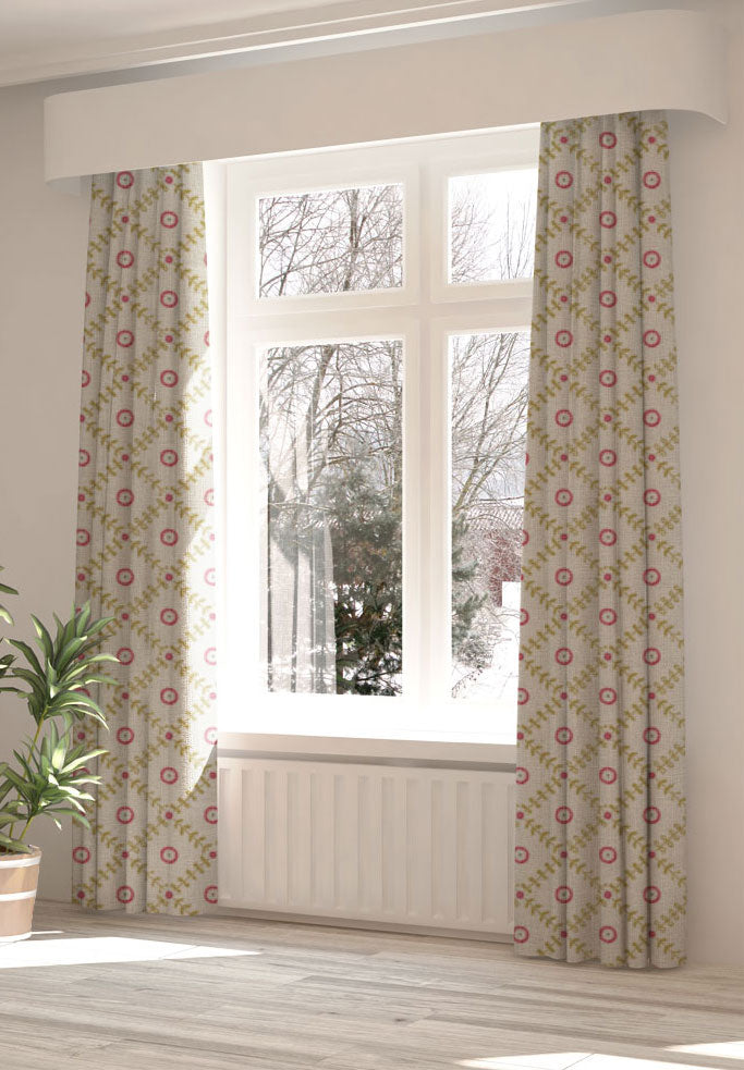 A large, sunny window with long curtains in a flower and leaf lattice print on a white field.