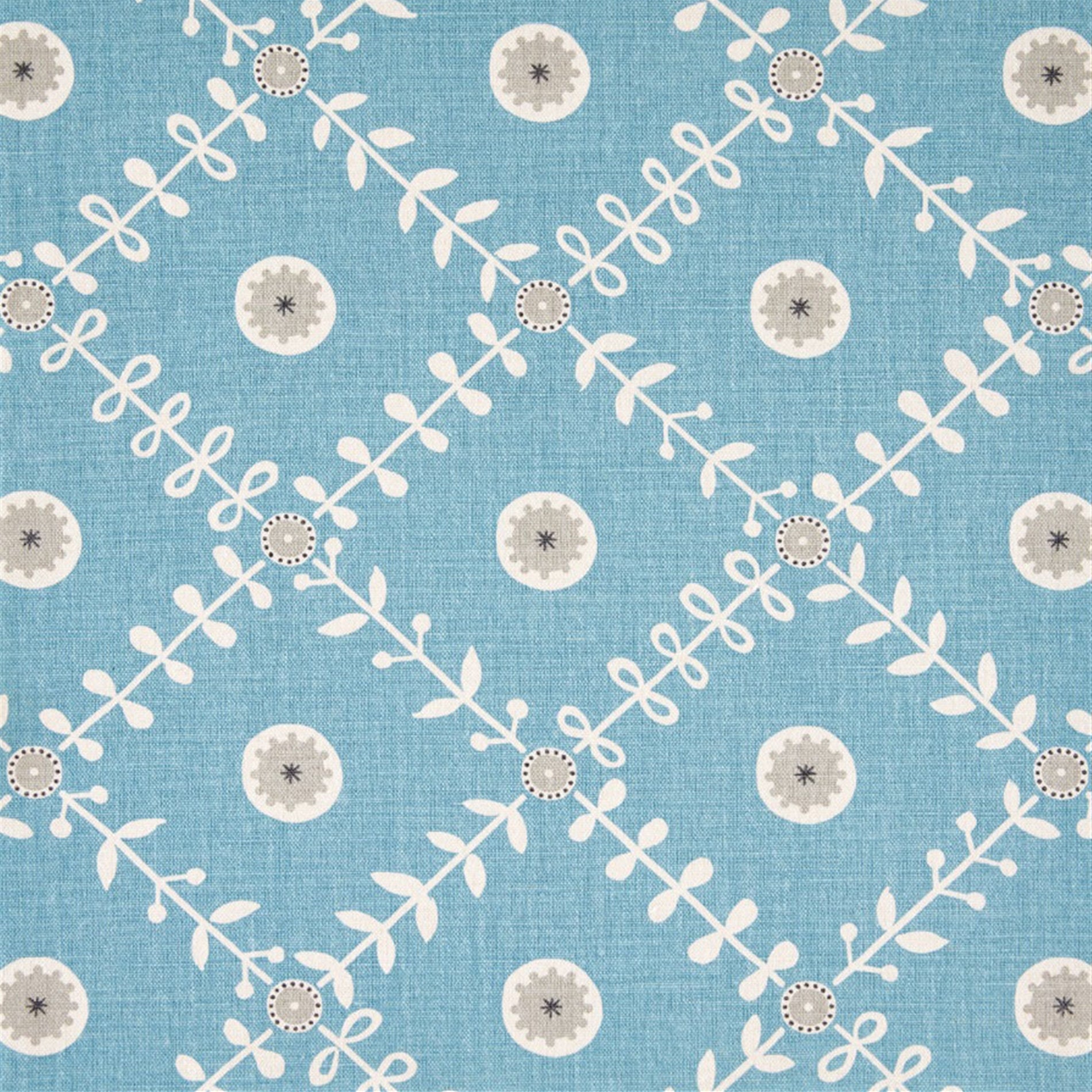 Detail of fabric in a flower and leaf lattice print in gray and white on a blue field.