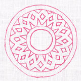 Detail of fabric in a repeating circular geometric print in fuchsia on a white field.