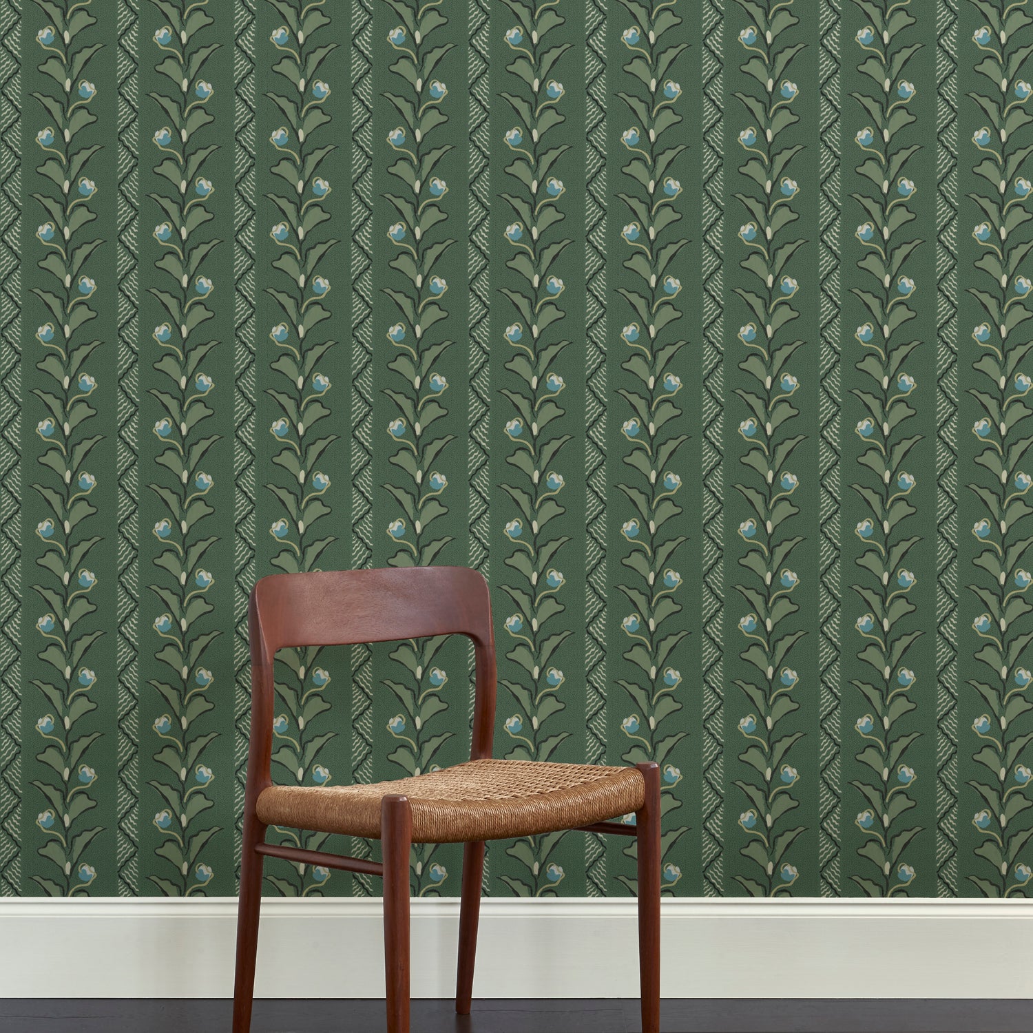 A wooden dining chair against a wallpaper in a painterly botanical stripe pattern in shades of green with blue accents.