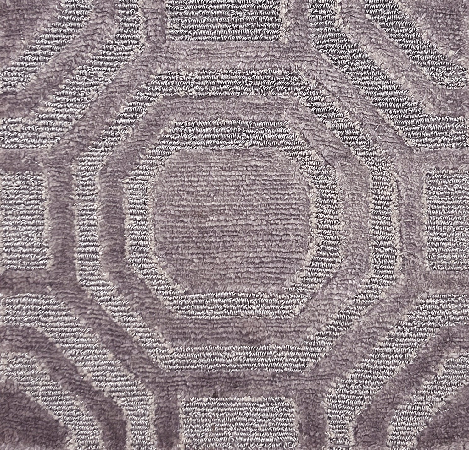 Close-up of textured metallic carpet with geometric pattern