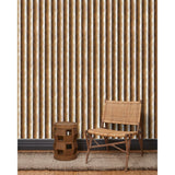 A wooden chair and end table in front of a wall papered in a curvy hand-painted stripe pattern in shades of brown, tan and white.