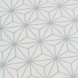 Fabric yardage with an embroidered floral lattice print in light gray on a cream field.