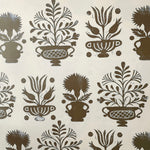 Detail of wallpaper in a repeating vase and plant print in brown on a white field.