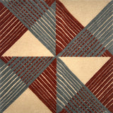 Handknotted rug in a geometric grid design in cream, red and slate blue. 