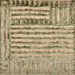 Detail of handknotted wool and silk with a raised green geometric pattern against a natural brown background.