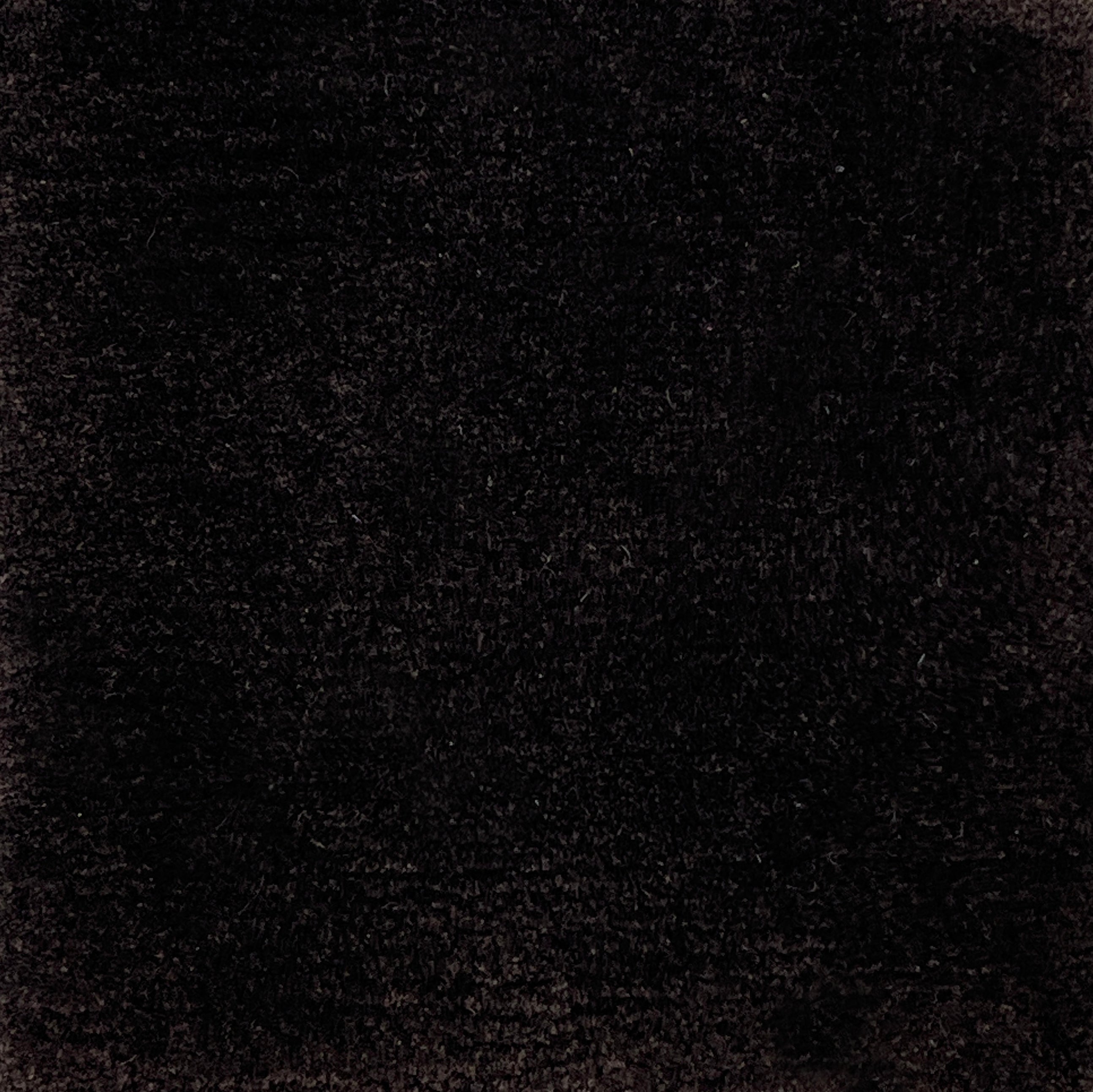 Handknotted cut pile rug in dark brown.