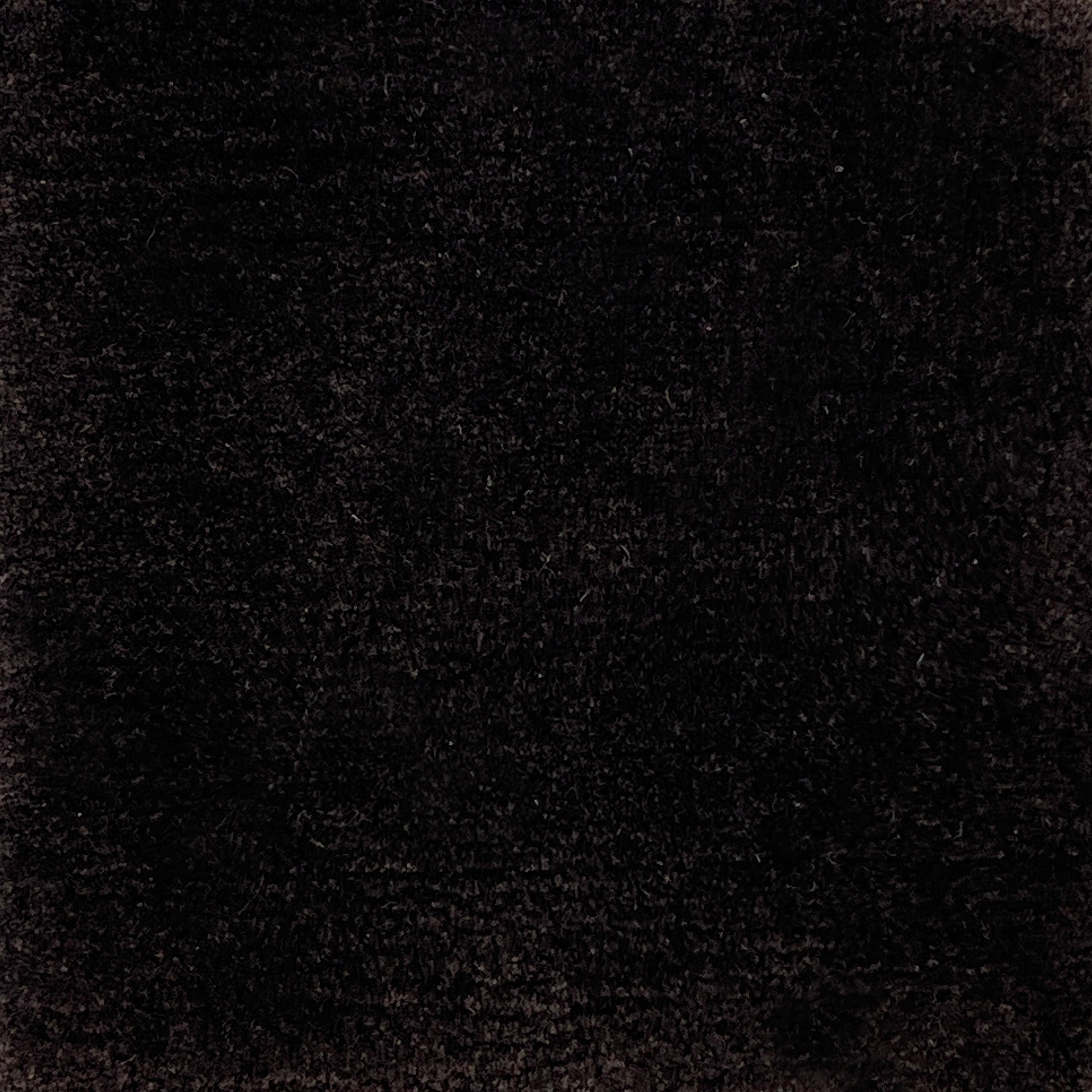 Handknotted cut pile rug in dark brown.