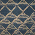 Handknotted rug in a geometric design in slate blue on a grey field. 