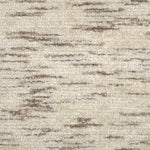 Handknotted cut pile rug in mottled oatmeal and cream.