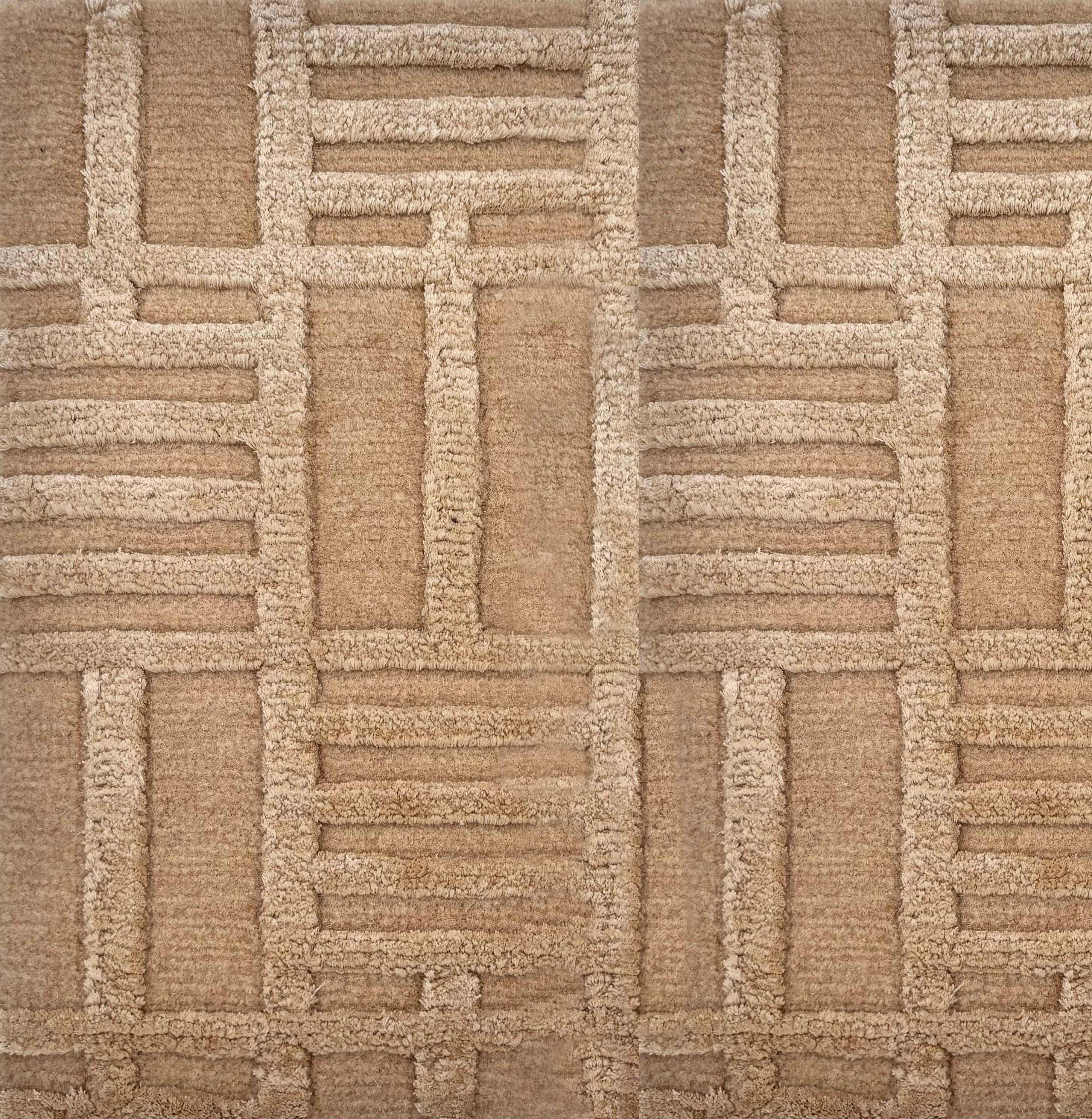 Detail of a Handknotted rug in beige with a raised linear pattern. 