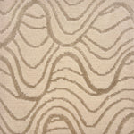 Handknotted rug in a wavy linear pattern in soft grey on a cream field. 