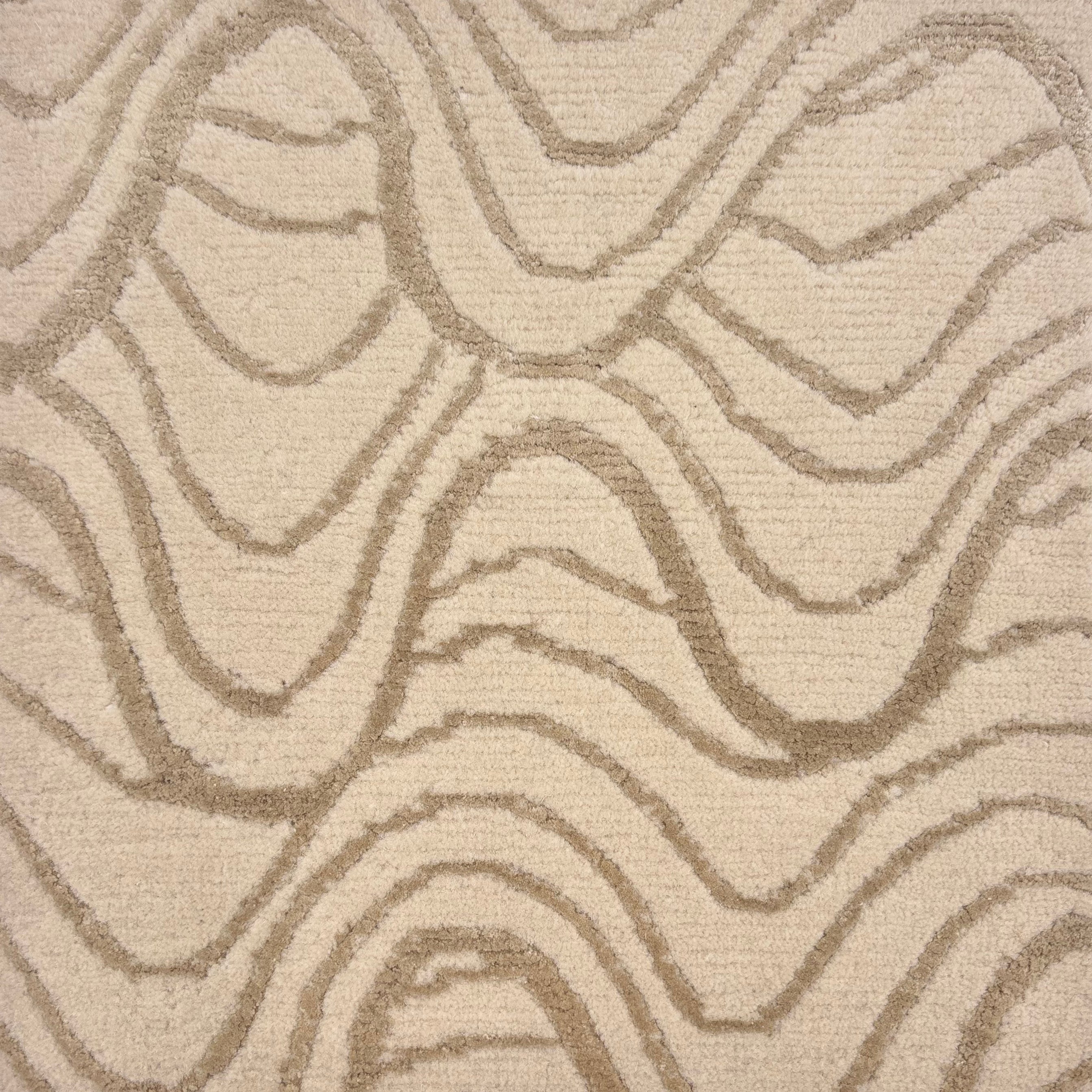 Handknotted rug in a wavy linear pattern in soft grey on a cream field. 