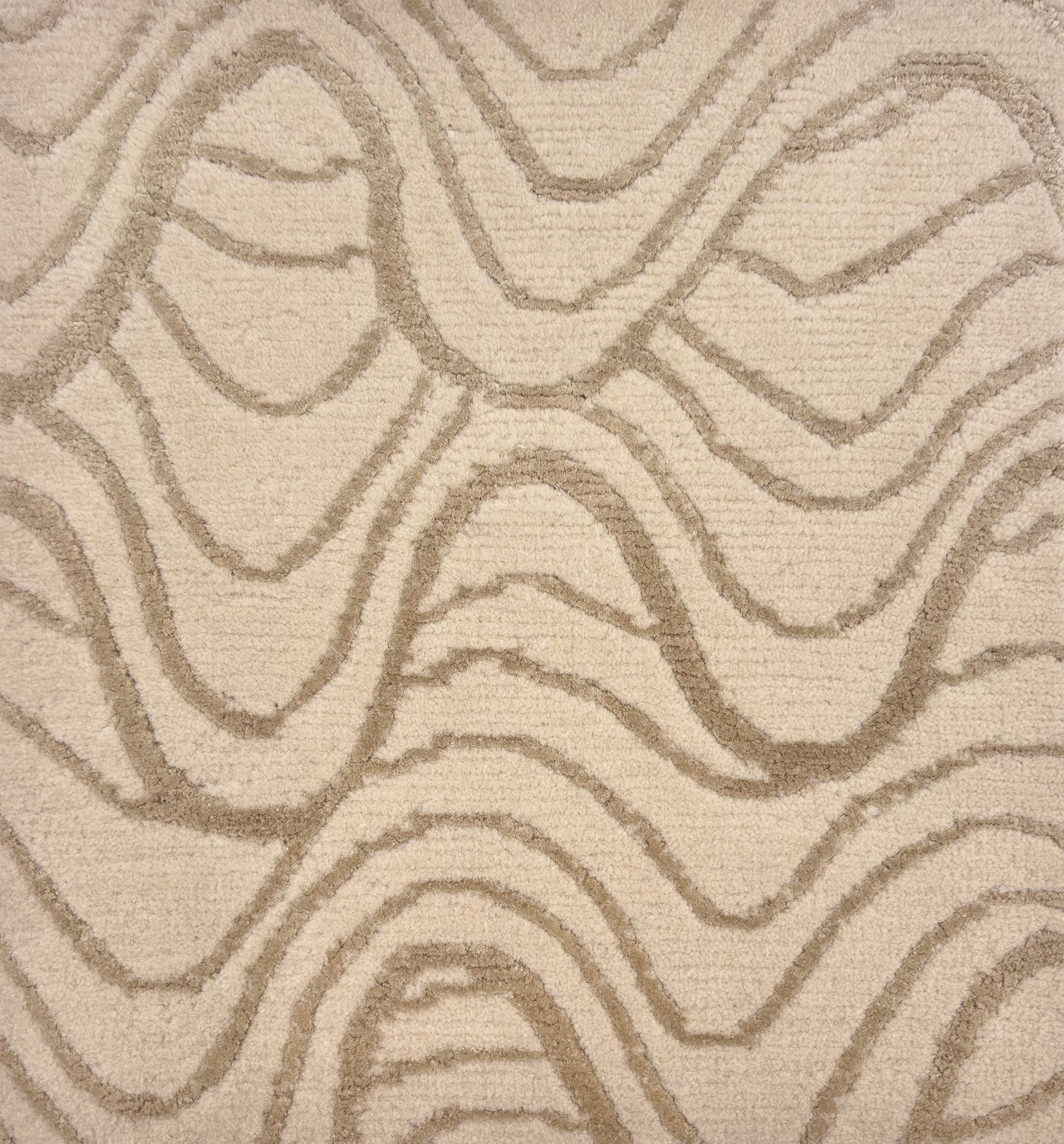 Handknotted rug in a wavy linear pattern in soft grey on a cream field. 