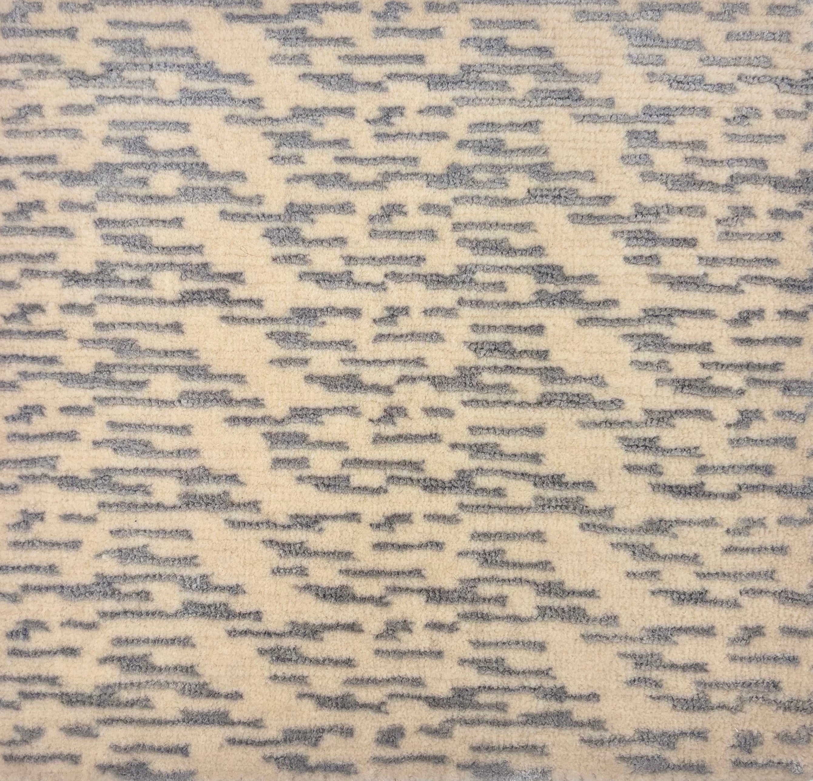 Handknotted M rug sample in a grey textural pattern on a cream field