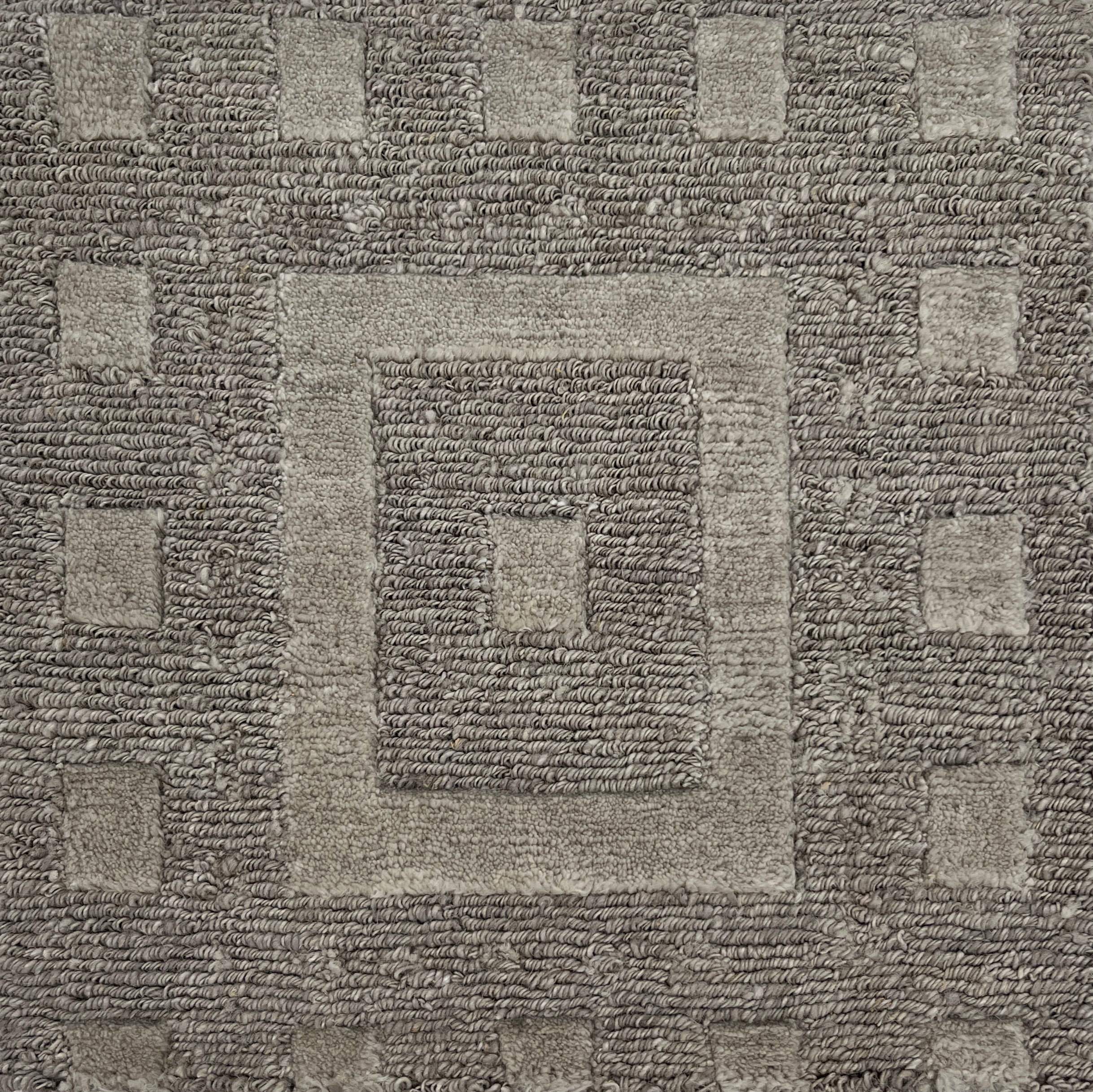 Close-up of a textured brown carpet with geometric pattern
