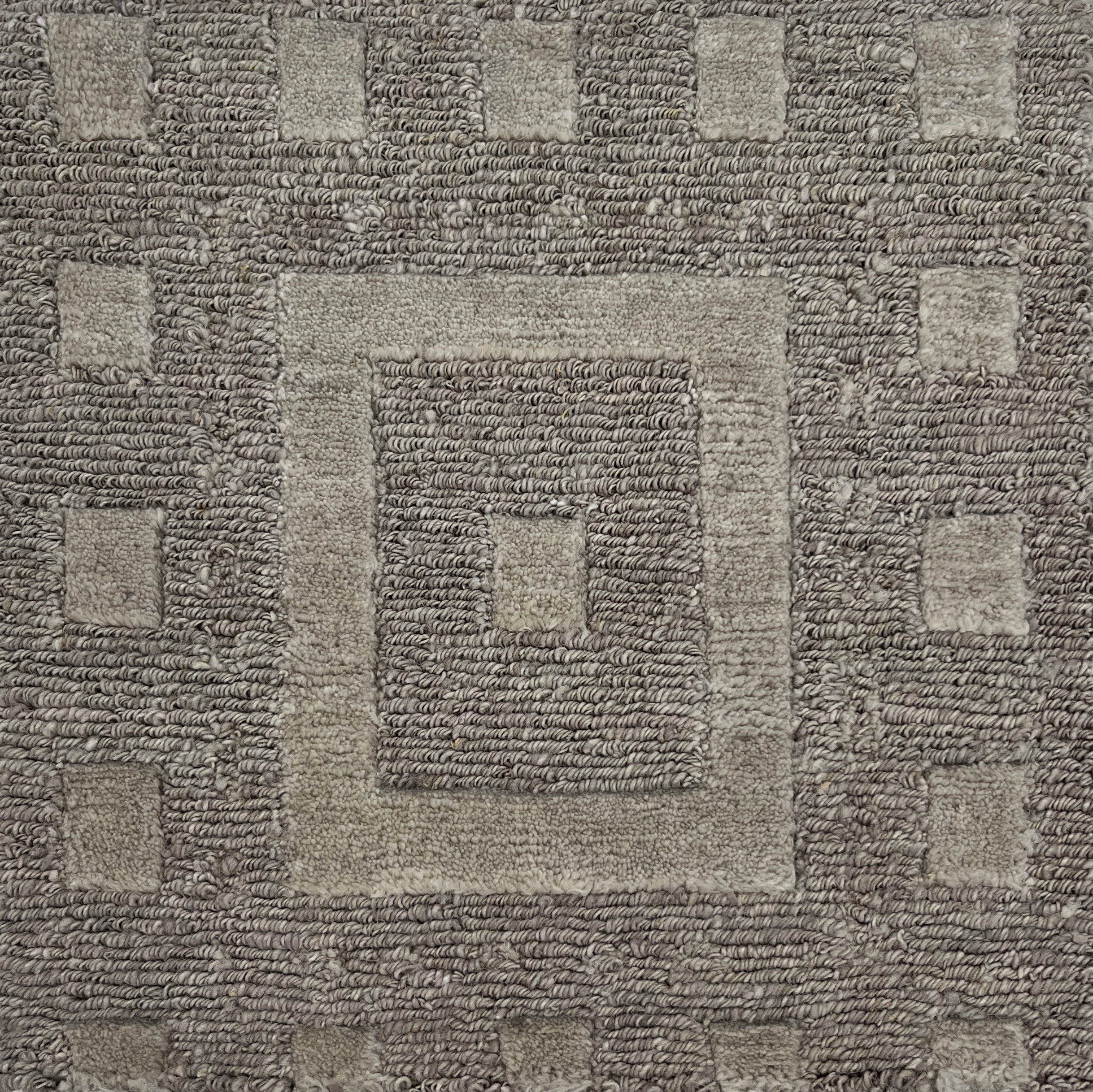 Close-up of a textured brown carpet with geometric pattern