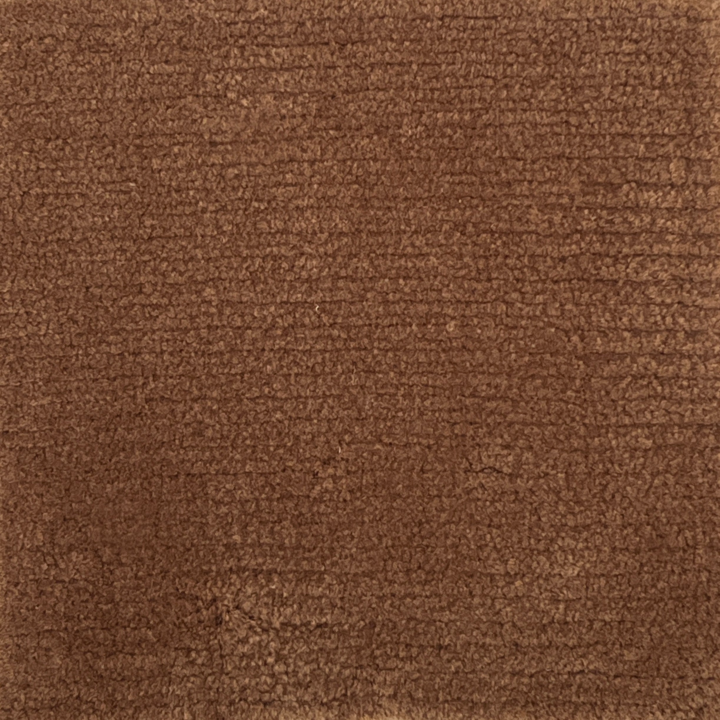 Handknotted cut pile rug in rust.