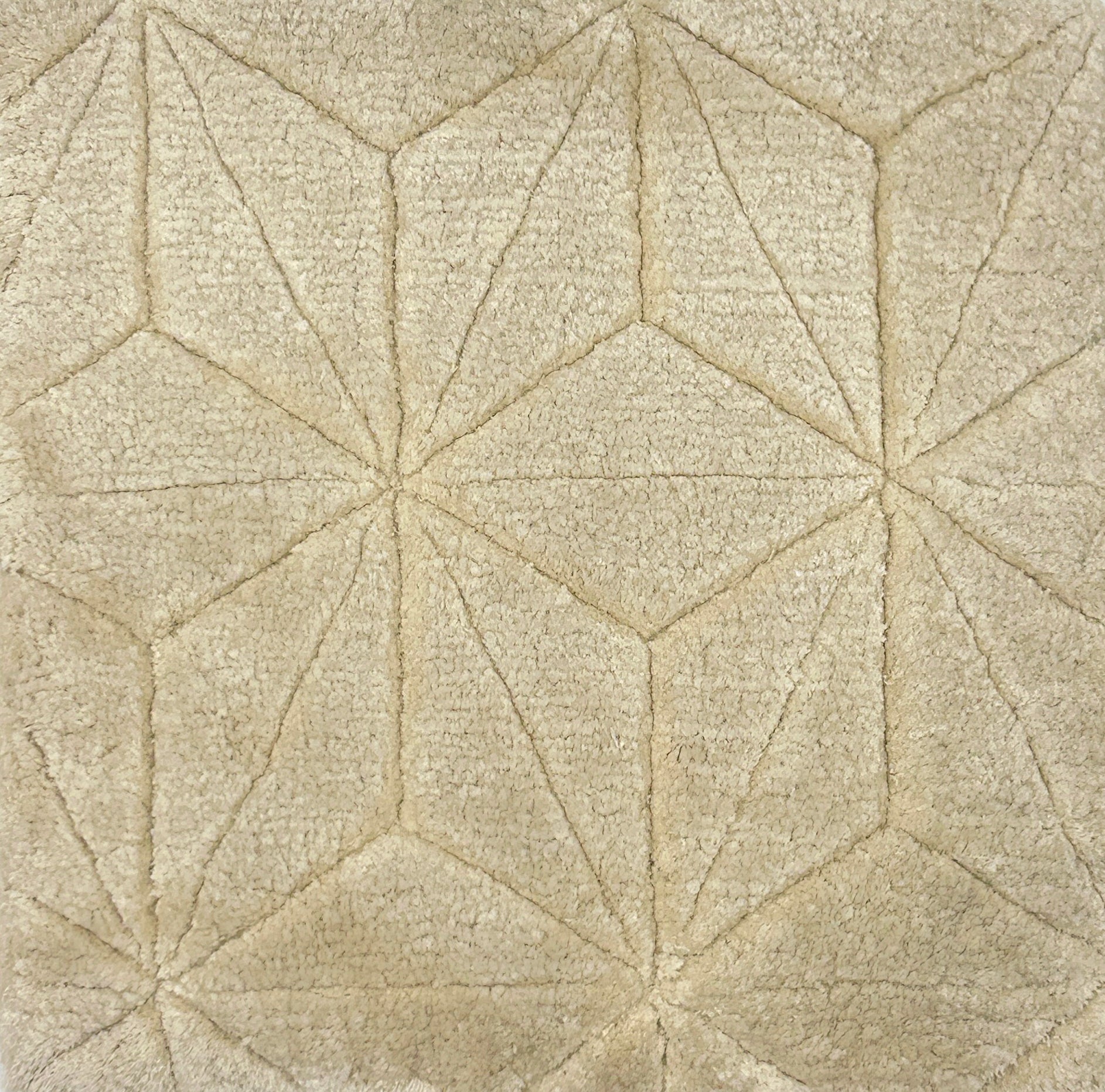 Handknotted carpet with carved star lattice design in cream