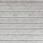 Detail of a handknotted rug in a cut pile stripe in ivory mohair.